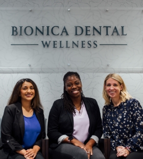 Woman in dental office smiling at dentist