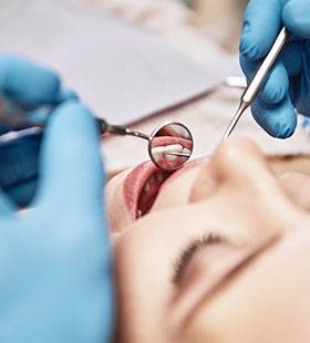 An up-close view of a person having their teeth cleaned by a dental hygienist