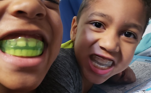 Two young children smiling during Healthy Start Sleep Treatment in Delafield