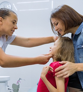 A mother and daughter at the dentist’s office undergoing an examination