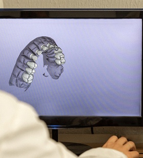 A dentist using technology to view an individual’s smile