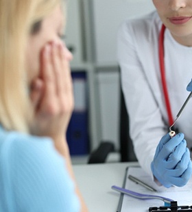 Woman asking questions of emergency dentist in Delafield