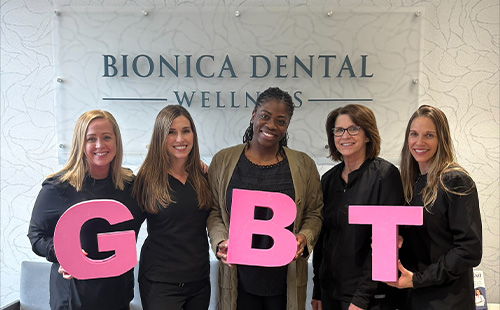 Bionica Dental Wellness team holding GBT letters in Delafield