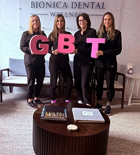 Dental team members holding GBT signs