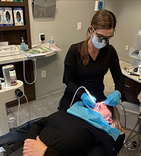 Dental hygienist using GBT to clean teeth