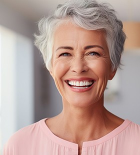 Middle-aged woman smiling with dental implants