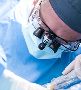 A dental professional performs implant placement on a patient