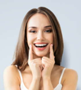 Woman pointing to her beautiful smile