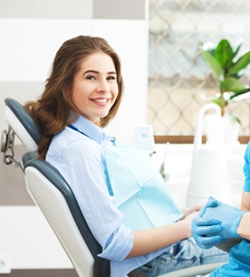 A female patient in the dentist’s chair alongside a male dentist