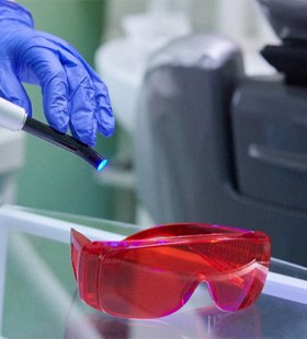 Up-close view of a dental laser and protective eyewear 