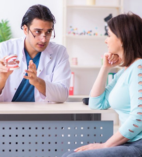 Dentist explaining what he will look for during screening 