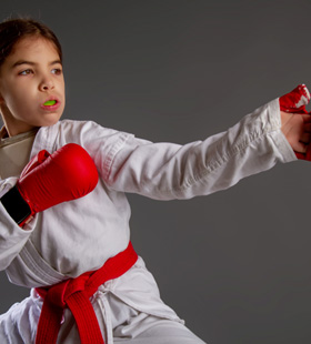 Young child wearing a mouthguard and preparing for martial arts