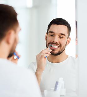 Man brushing teeth in Delafield
