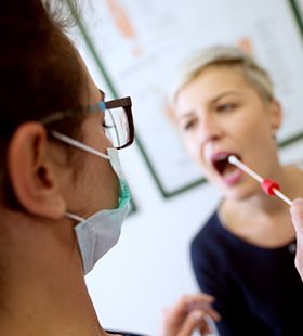 Patient receiving saliva pH testing