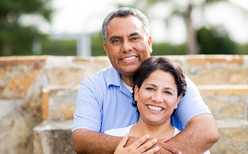 Older man and woman smiling outdoors