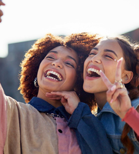 Two friends smiling and laughing together 