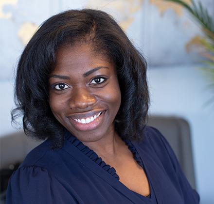 A personal photo of Dr. Udoka Holinbeck smiling in her office