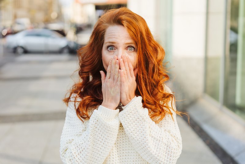 woman covering her mouth