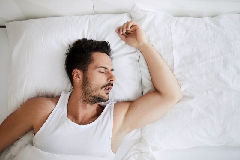 man asleep and snoring in bed