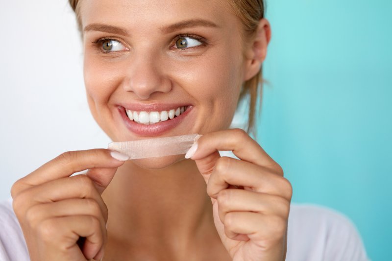 woman using whitening strips