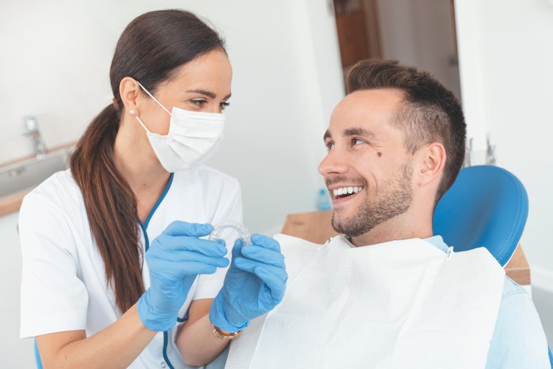 man listening to dentist discuss Invisalign